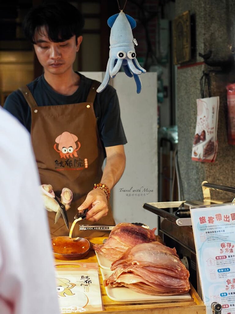 魷布院正在剪試吃魷魚的店員