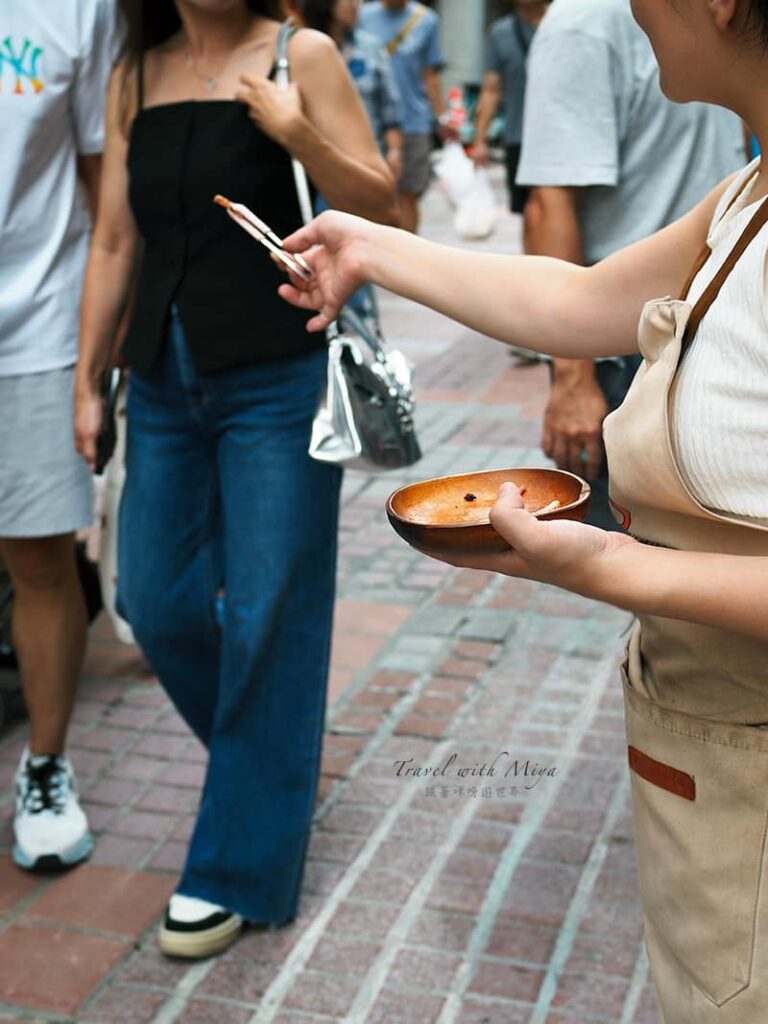 魷布院店員分送魷魚給路人試吃